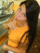 Hot babe walking around the mall wearing her orange shirt, vari-colored floral skirt and pink and brown slippers before she pose her smoking hot body