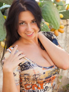 Cute young hottie lifts up her vari-colored shirt then reveals her sweet boobs before she strips it off then pulls down her gold thong and displays he