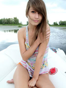 Doll in a pink printed jacket gets in her birthday suit on a boat.