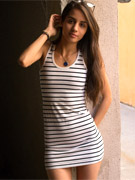 Slim brunette in a striped dress and glasses gets naughty in the supermarket