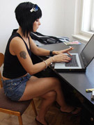 Edgy raven-haired hottie smoking cigarettes while surfing the net at home meets john for paid sex session.